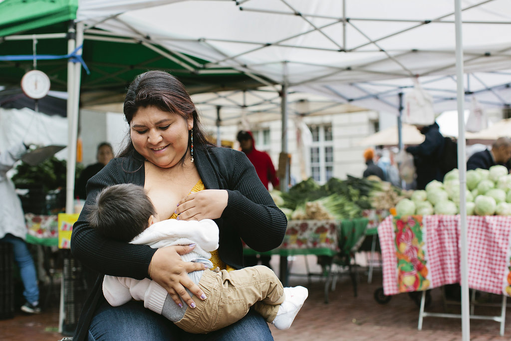 woman breastfeeding at farmer's market