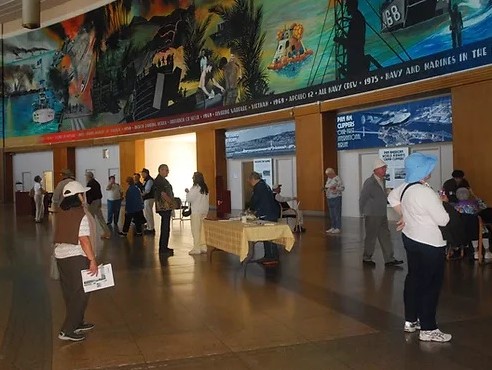 The Treasure Island Museum space is shown, with the history of the Navy mural behind it