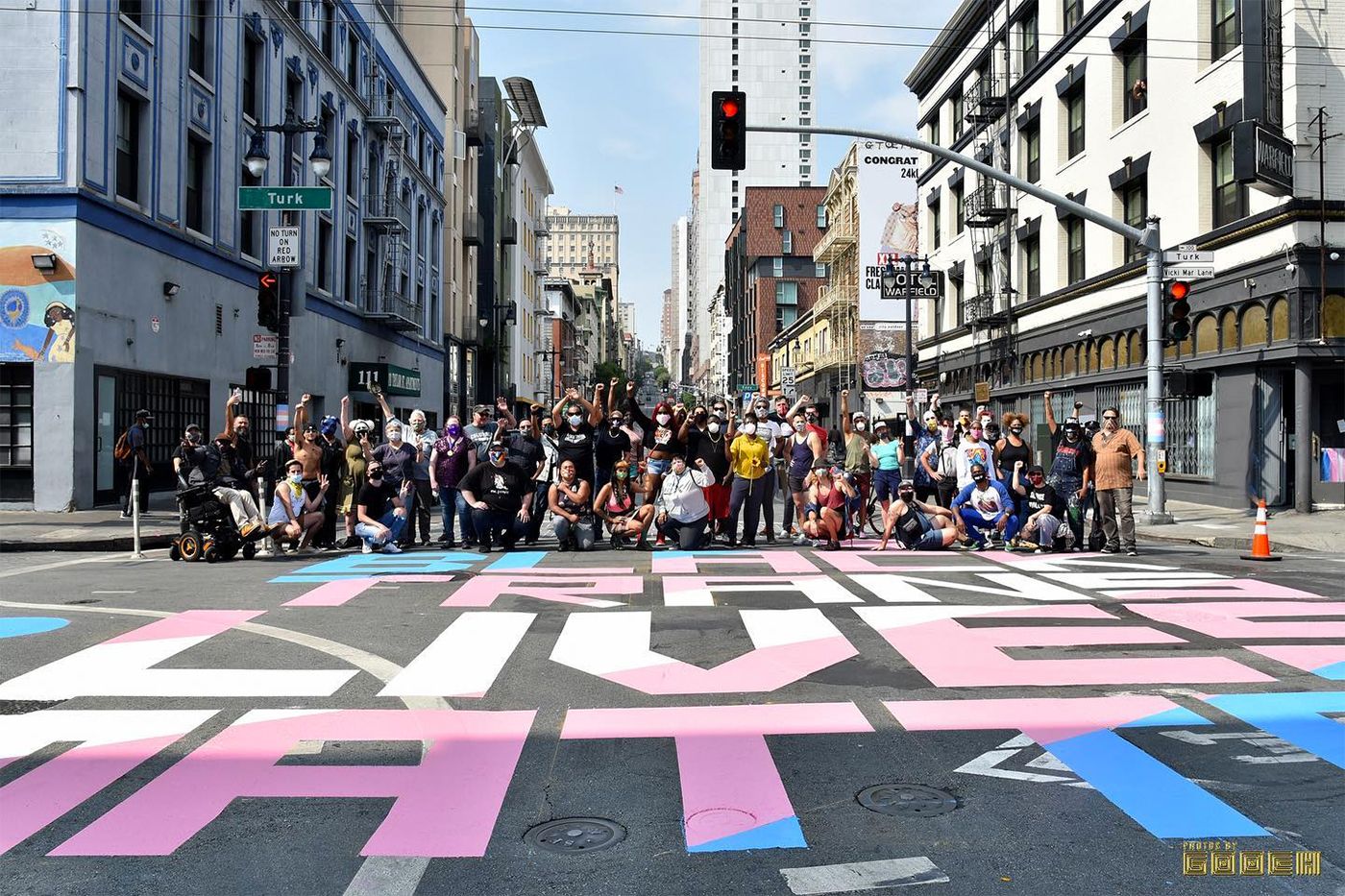 Photo shows crowd of supporters posing by "Black Trans Lives Matter" street mural