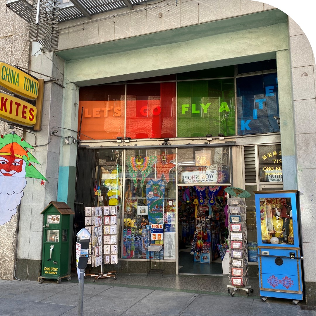 Photo of the storefront with rainbow colored windows