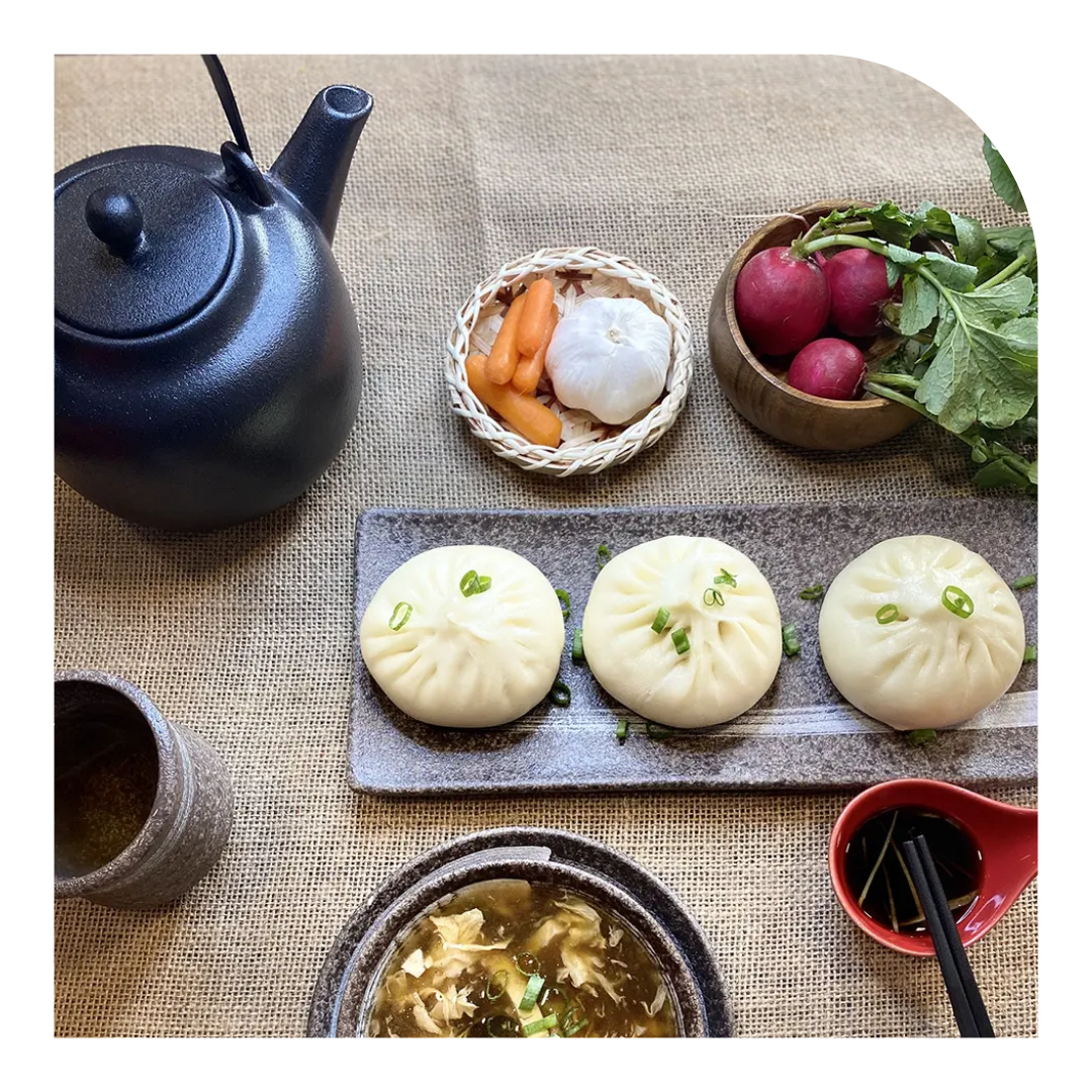 overhead photo of dumplings and a kettle of tea