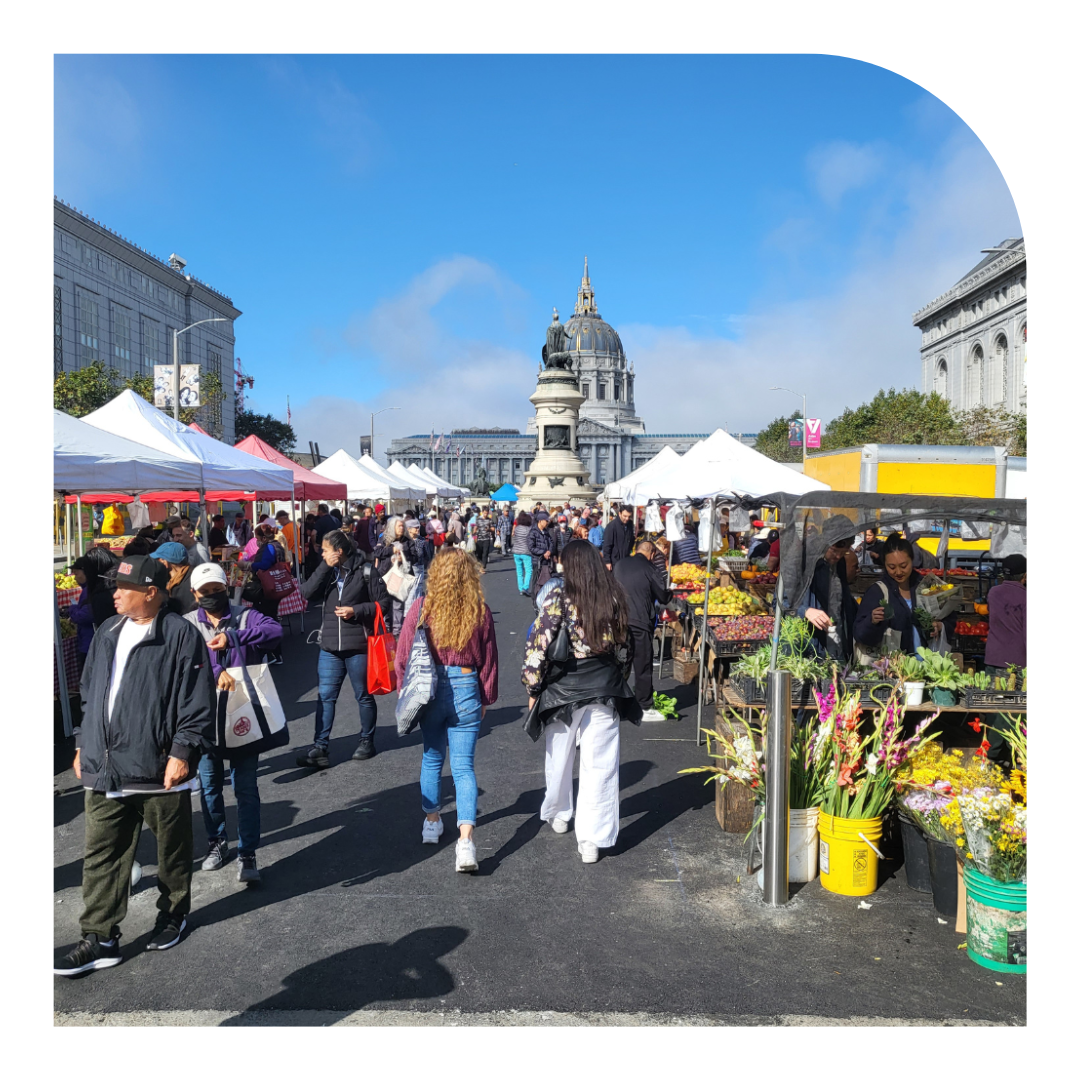 photo of a farmers market on a sunny day
