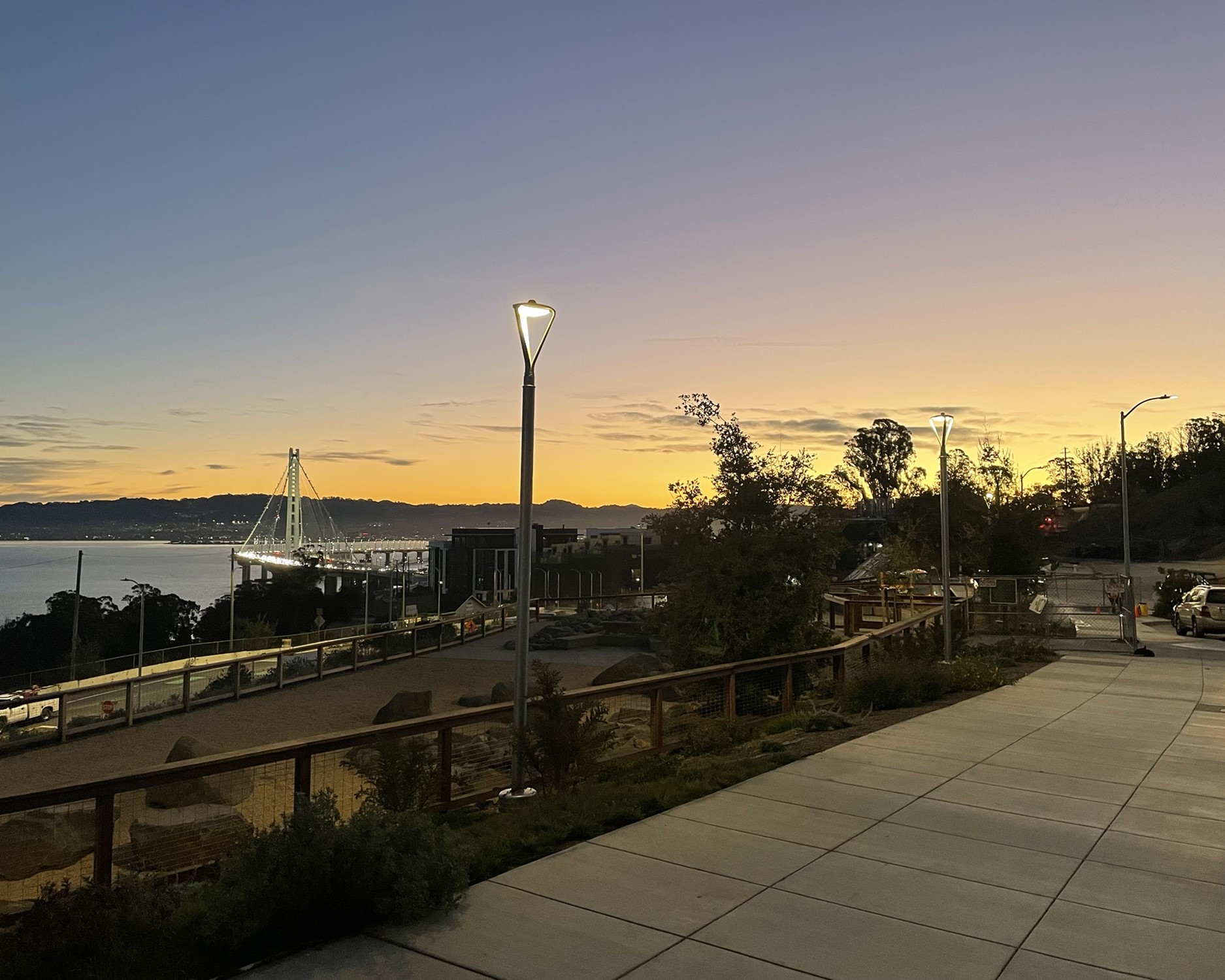 YBI Dog park shown at sunrise with the Bay Bridge behind it