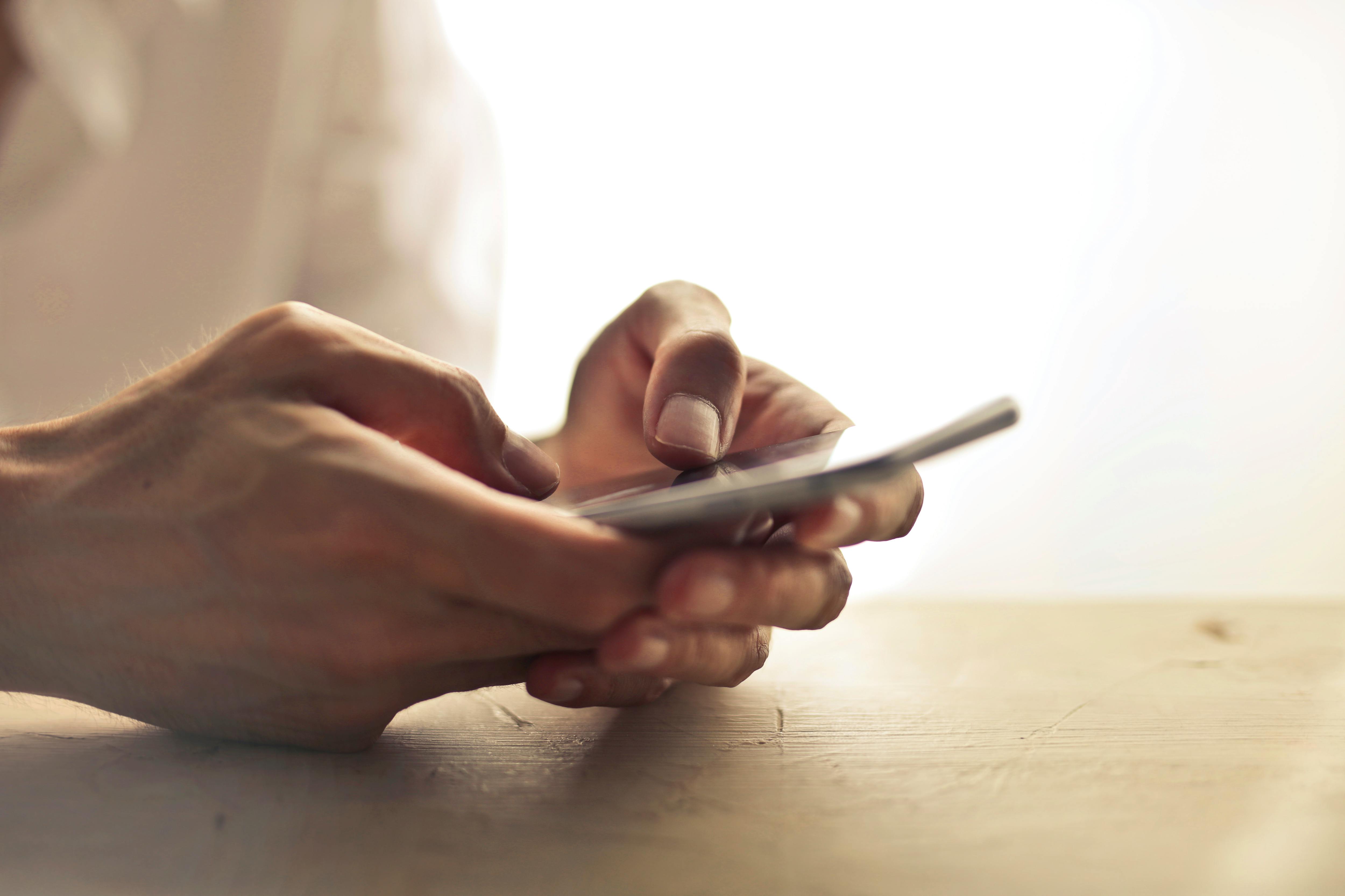 two hands holding a cell phone