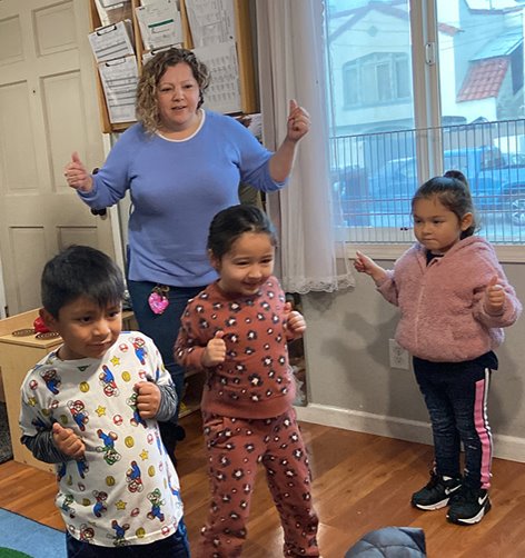 children in early childcare setting enjoying physical activity with their caregiver