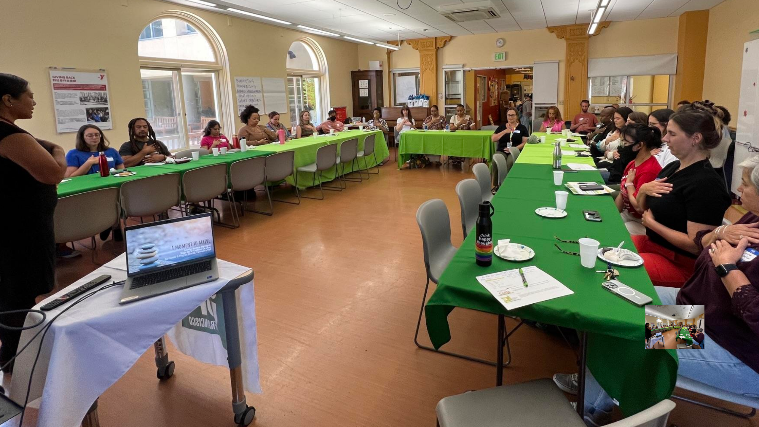 people with hands on hearts in meeting