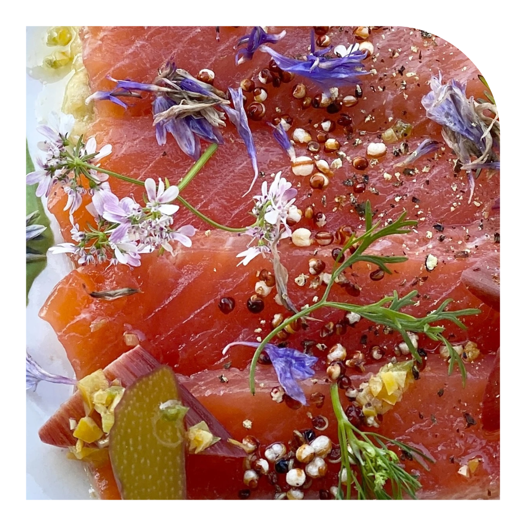 photo of a plate of fish with floral garnish