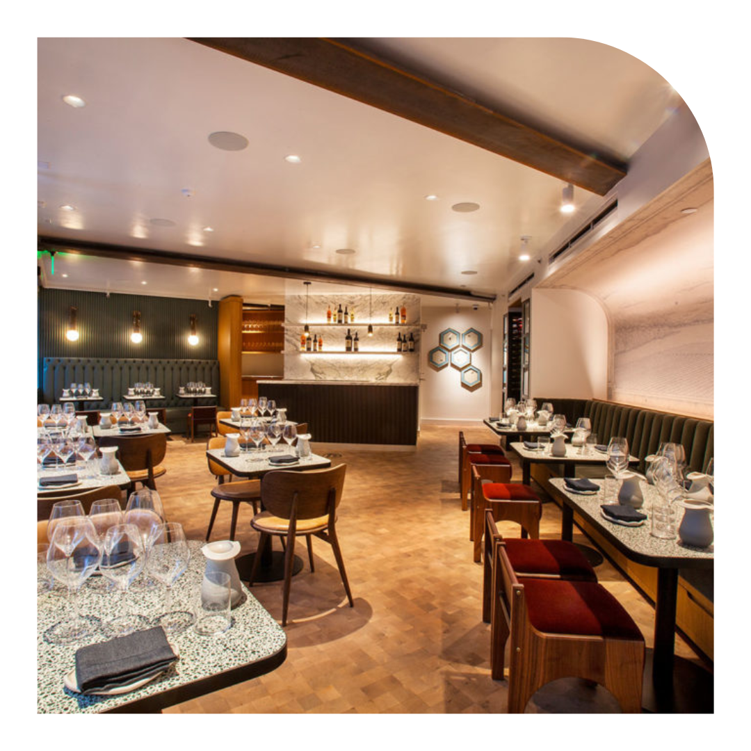 photo of a restaurant with glasses on the tables