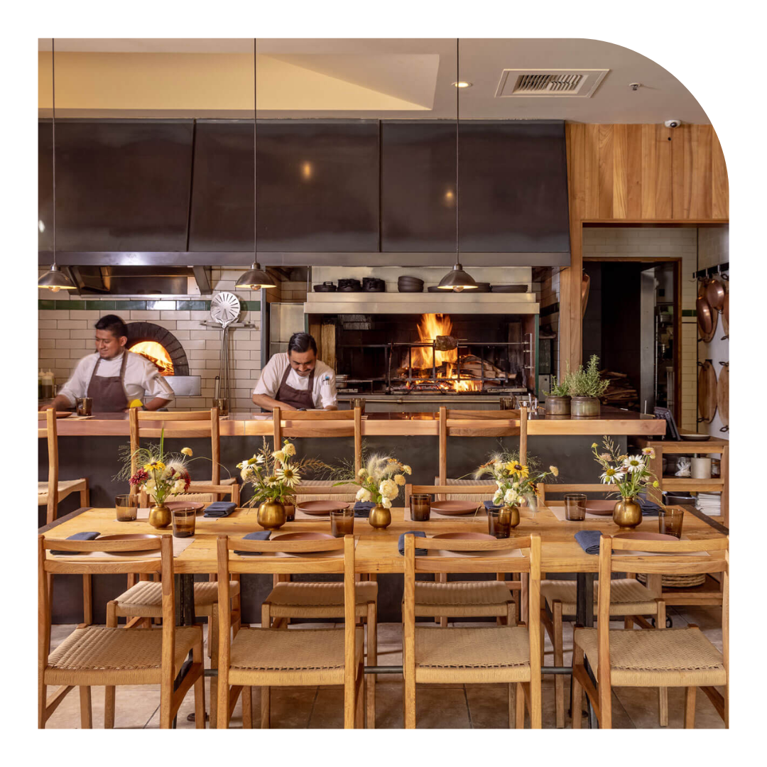 photo of chefs preparing food in an open concept kitchen