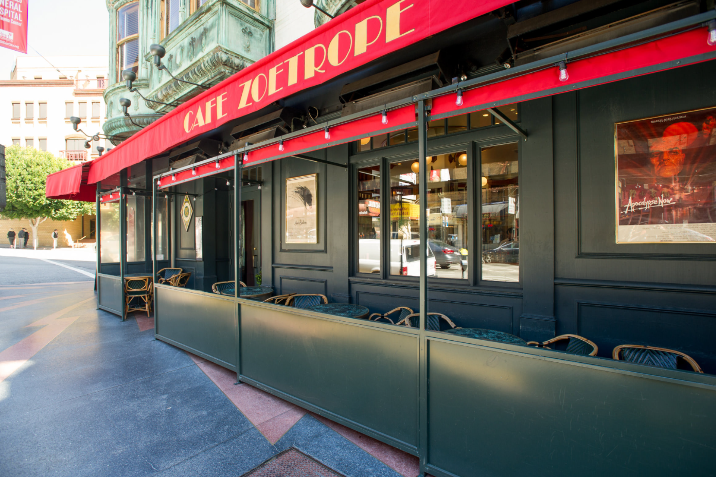 photo of a storefront cafe with a large red awning