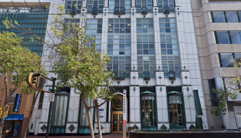 Front of a white tiered office building in downtown San Francisco.