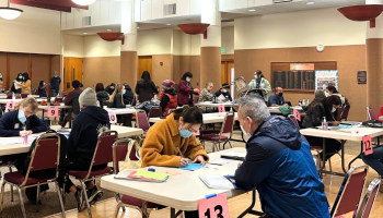 A volunteer helps someone apply for U.S. citizenship during a free workshop