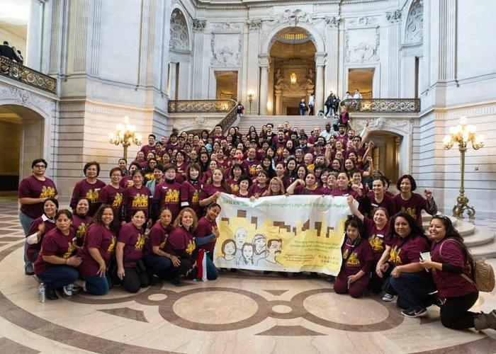 Participants of Annual Immigrant Family Day take a picture in the San Francisco City Hall foyer.