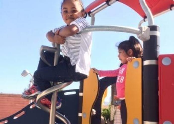 Child plays on the playground set at the new Booker T. Washington Center