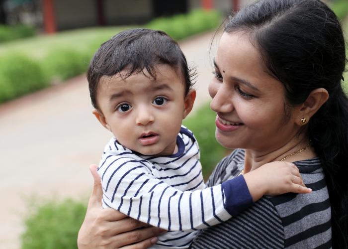 Mother smiling at small baby 