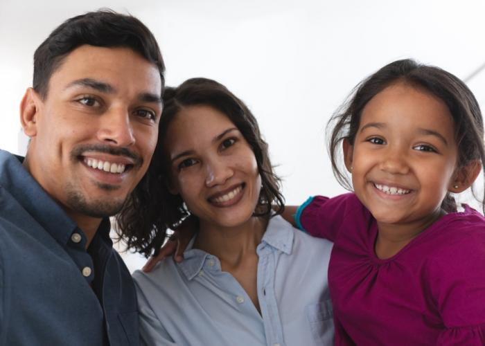 Couple and daughter smiling