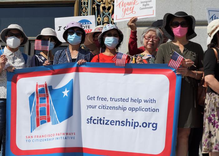 Group of newly naturalized citizens attend press conference at City Hall