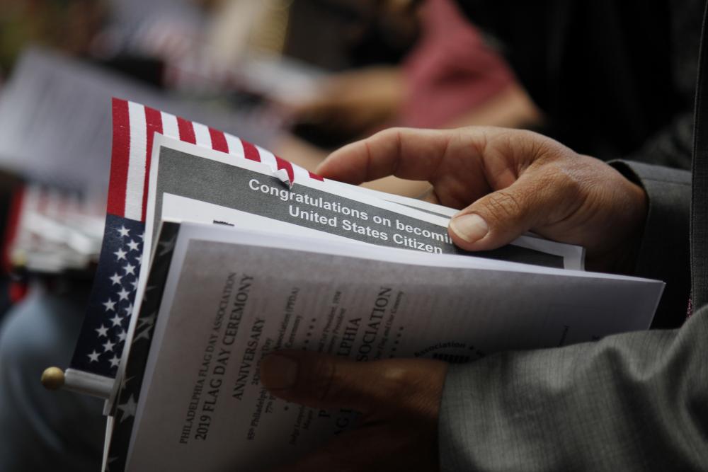 Person holds documents at U.S. Naturalization ceremony