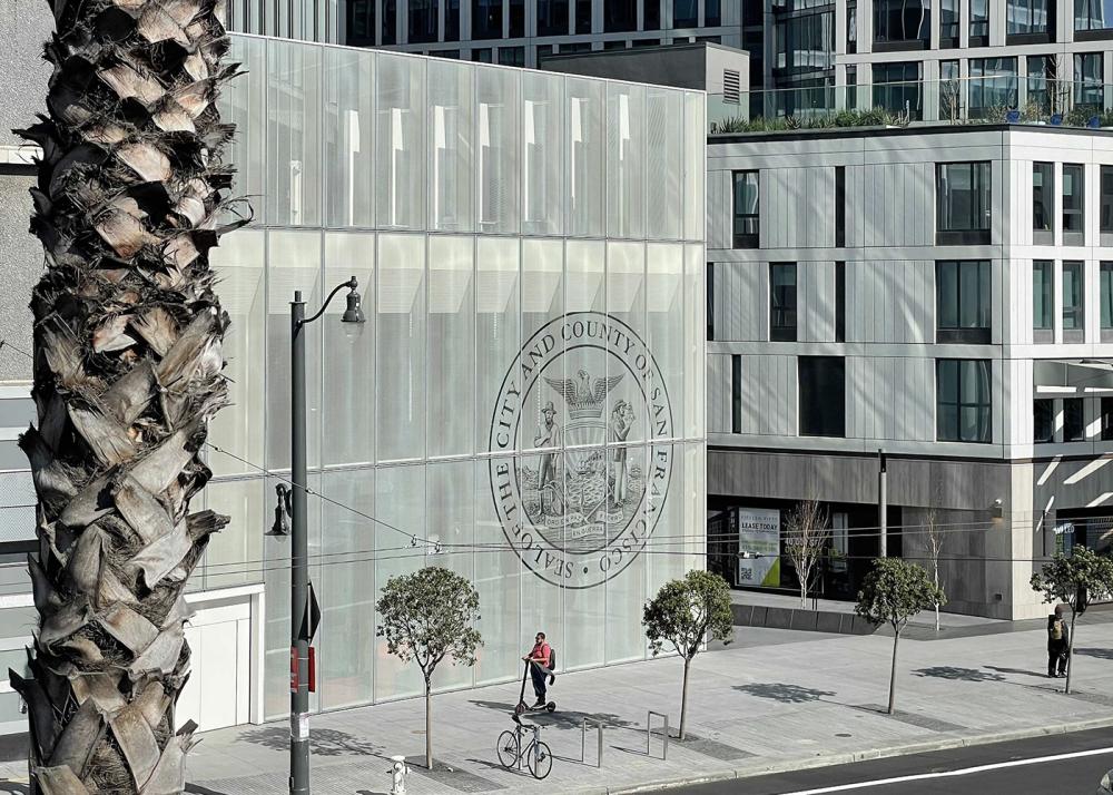 The entrance of the Permit Center, with the City seal engraved on 2 stories of the glass facade.