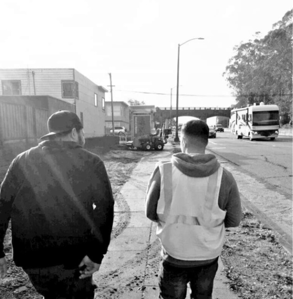 DPO Reyes, of the TAY Unit, walks along side of his client at a Conservation Corp jobsite. DPO Reyes was instrumental in helping this client obtain employment and worked with him to learn the skills to help him keep it.