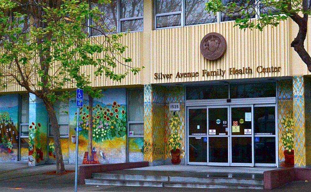 silver avenue family health center building with mural painting and front entrance