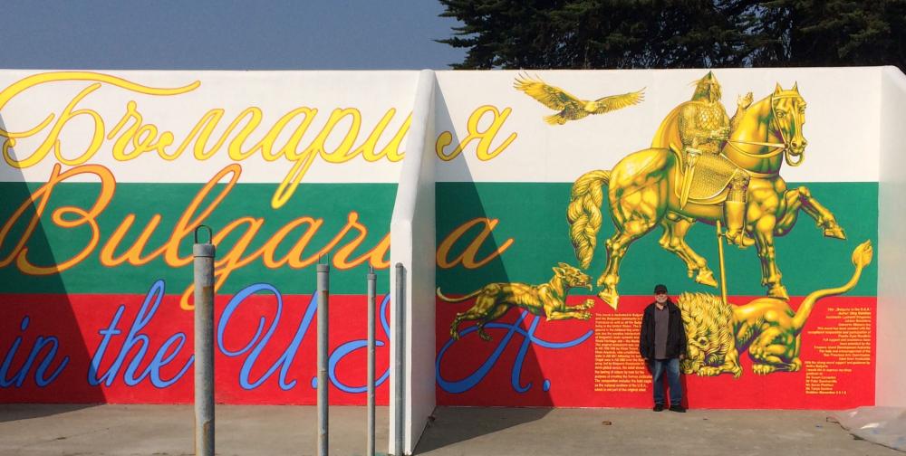 A mural showing artist Oleg Gotchev in front of his interpretation of the Madera Rider and an image of an eagle