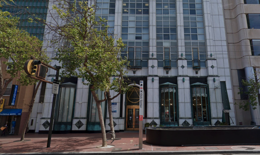 The entrance to 1145 Market Street, a white office building in downtown San Francisco. 