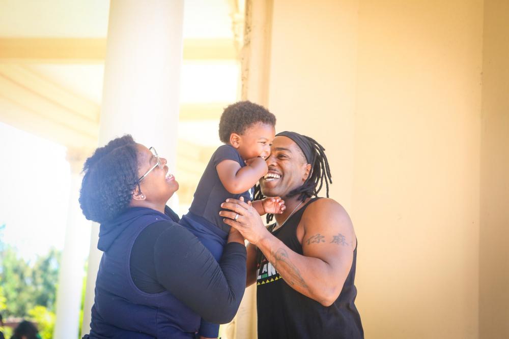 Young mother and father holding baby