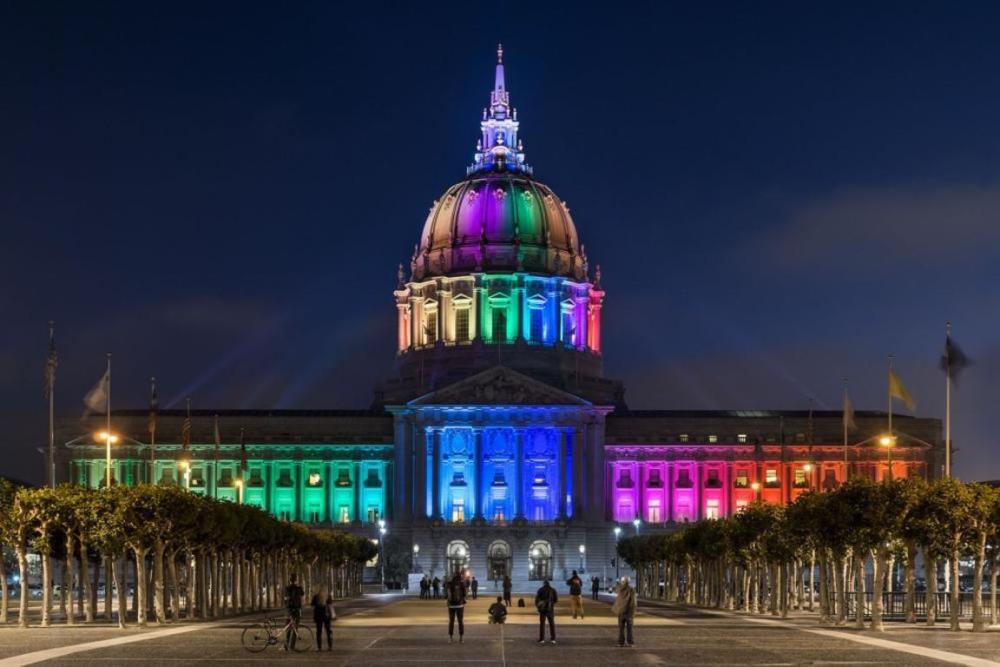 Exterior of City Hall with colorful rainbow lighting