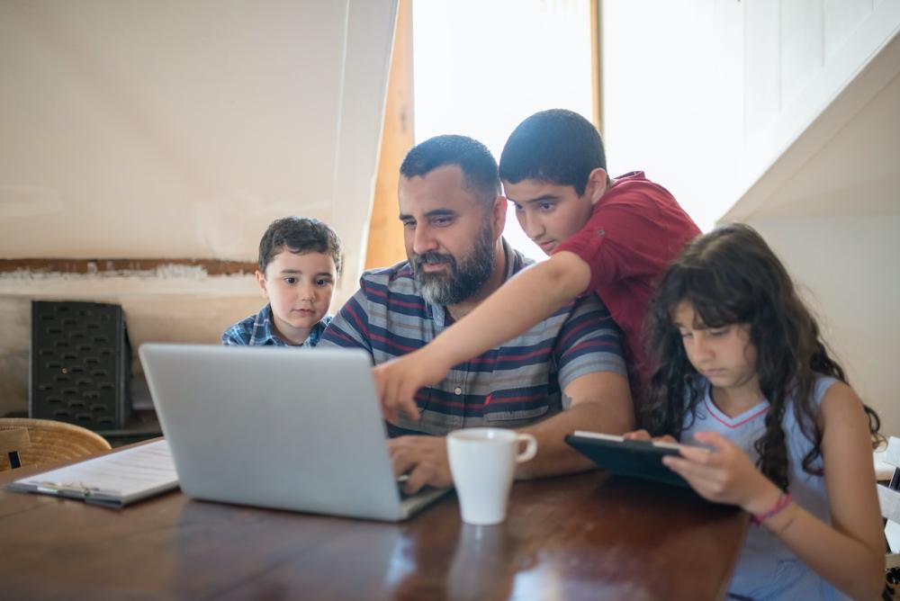 Father with his Children Looking the Laptop