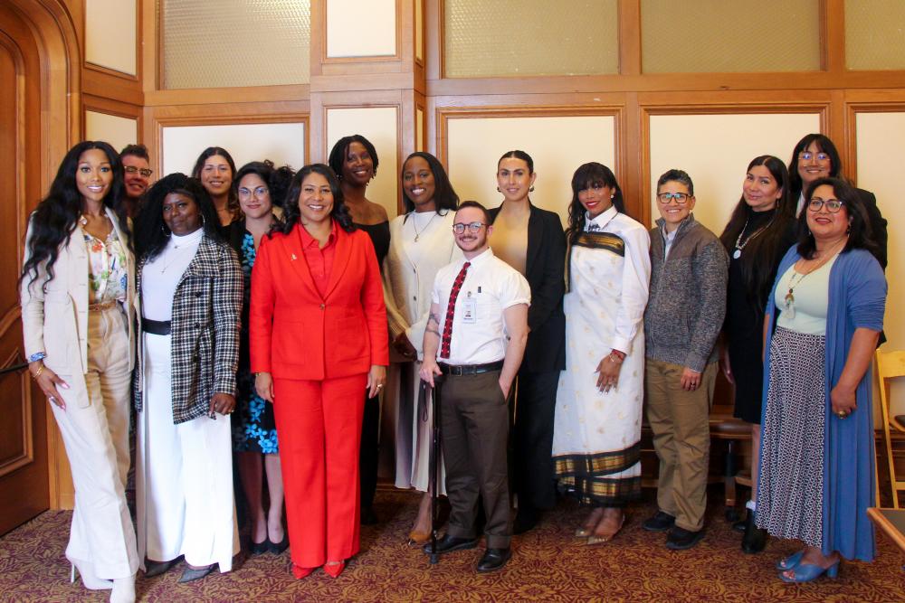 members of the Trans Advisory Committee posed for a photo with Mayor London Breed