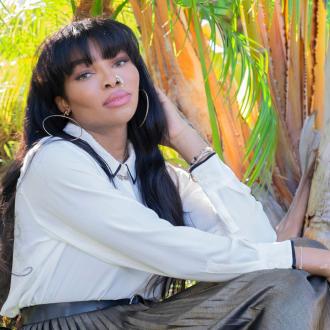 Picture of Lana Patel in white blouse sitting in front of trees