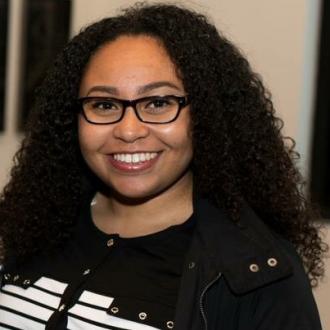 Jada Curry wearing glasses and smiling