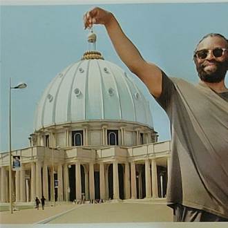 larry chew with a hand on top of city hall